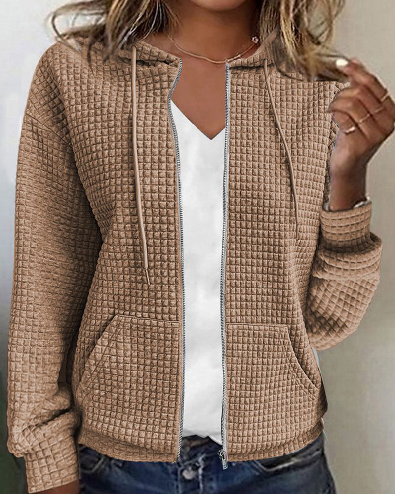 Cozy women's textured zip-up hoodie with front pockets & an adjustable hood, offering stylish everyday comfort.