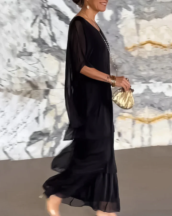 Side view of a women's long sleeve tiered maxi dress, showcasing the relaxed fit and movement of the fabric.