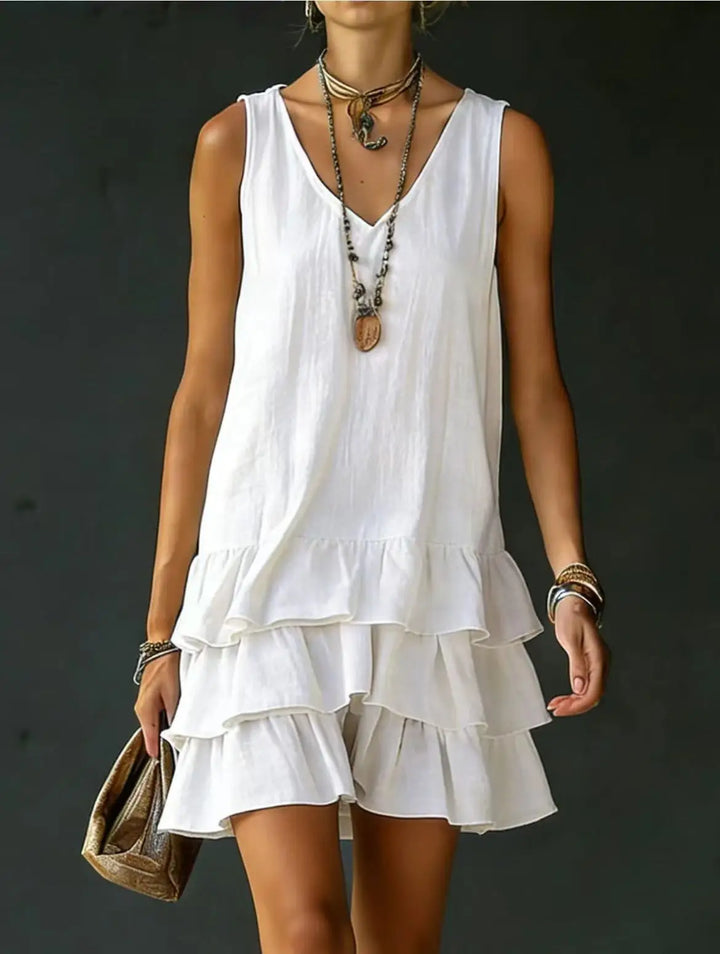 Feminine V-neck sleeveless mini dress with stylish tiered ruffles for women. Ideal for casual summer days.