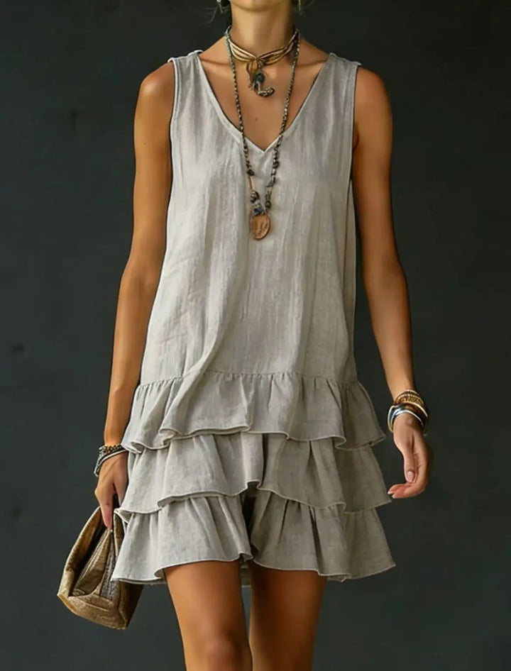Versatile tiered ruffle mini dress for women, sleeveless V-neck. A stylish summer vacation & beach outfit.