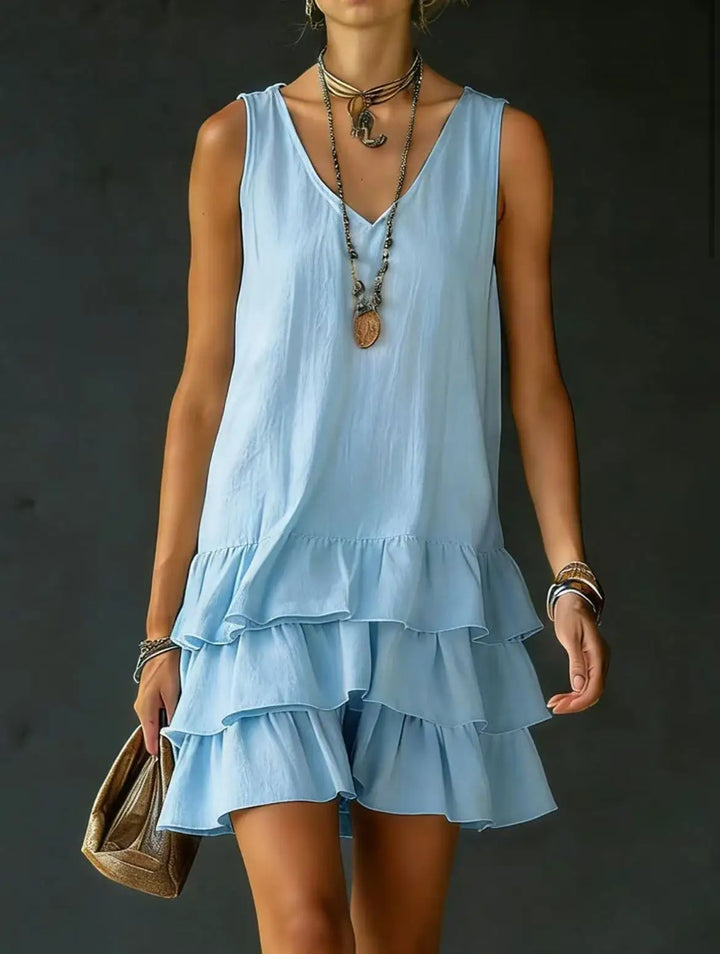 Trendy tiered ruffle mini dress for women, sleeveless V-neck. Perfect casual summer style or beach wear.