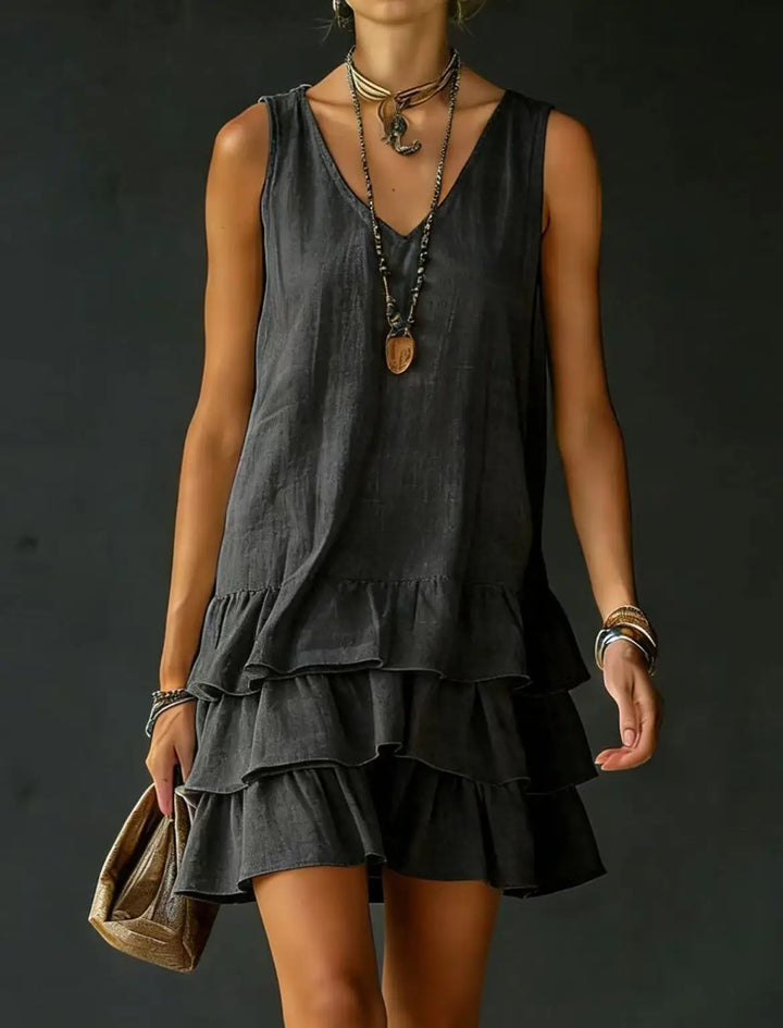 Women's sleeveless V-neck tiered ruffle mini dress. Casual summer style for day, vacation, or beach.