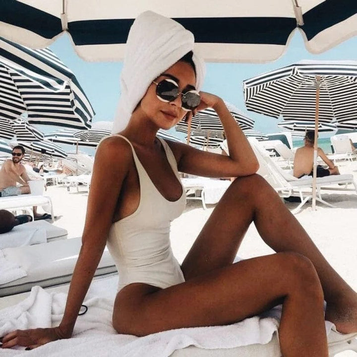 Flattering scoop neck one-piece swimsuit for women, ideal for poolside relaxation, beachwear & summer style.
