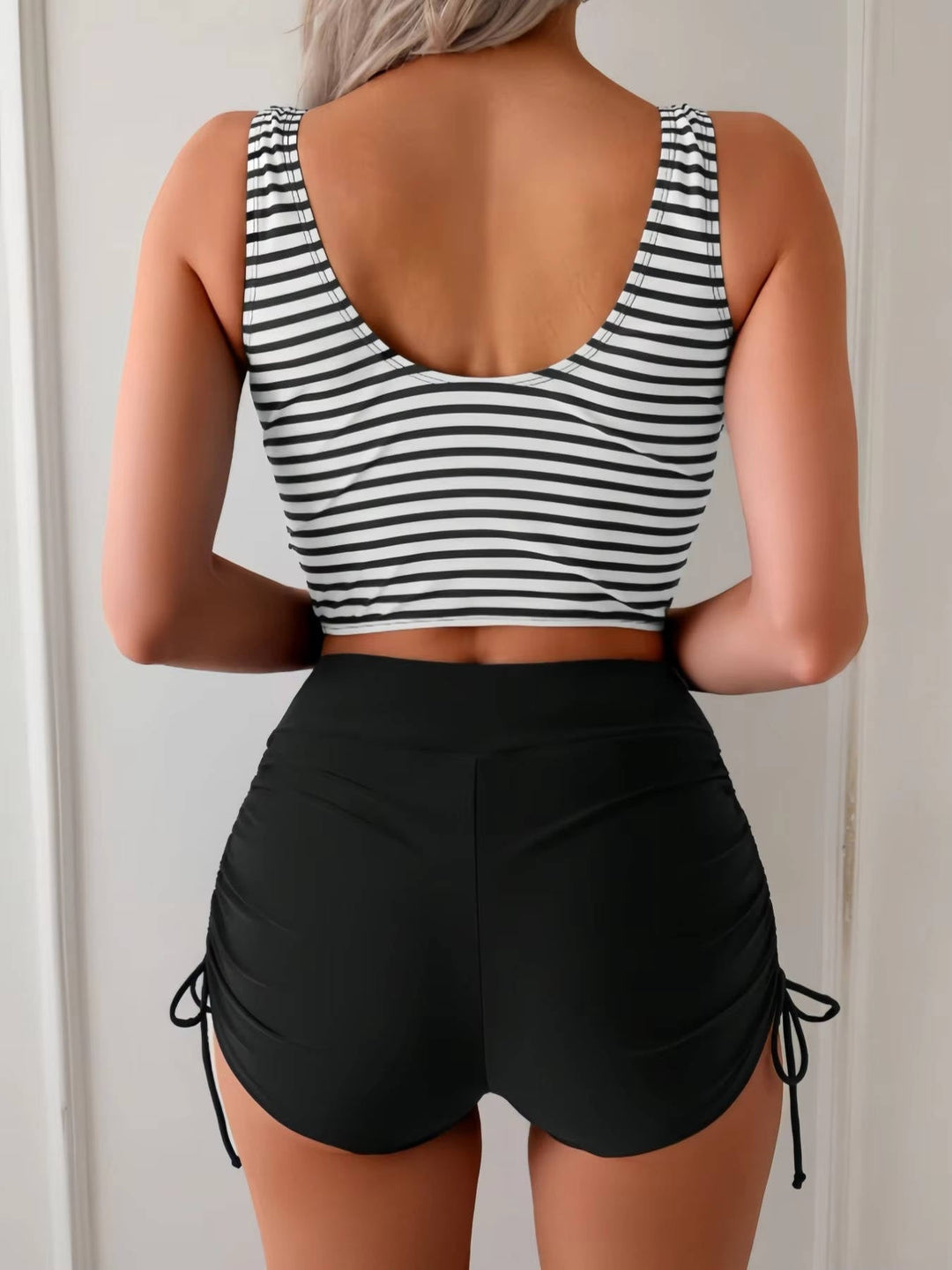 Elegant women's tankini, featuring a twisted front and supportive high-waisted swimsuit bottom.