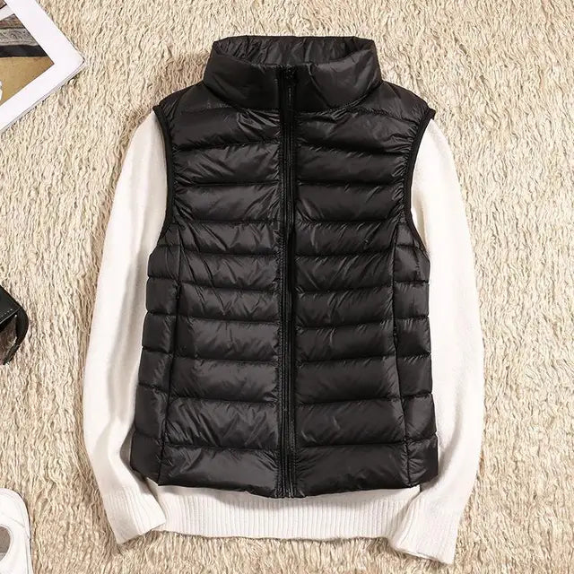 Women's ultra-light down vest in black. Warm, lightweight & packable for fall/winter layering.