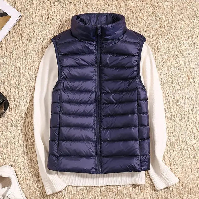 Casual women's black ultra-light down vest. Stylish & warm layering piece, perfect for everyday fall & winter outfits.