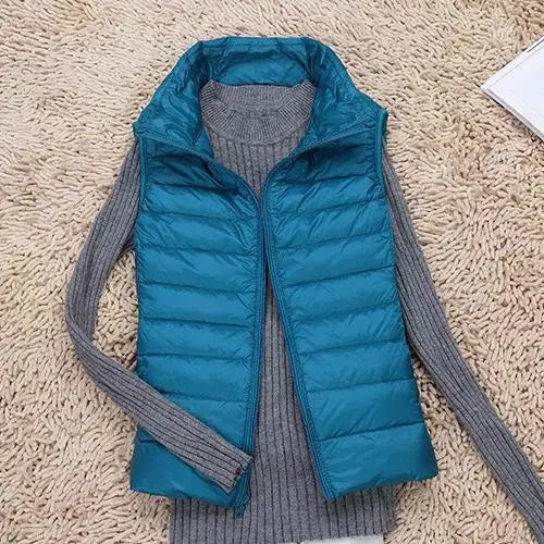 Stylish women's lightweight down vest in navy blue. Perfect warm outer layer for casual fall fashion.
