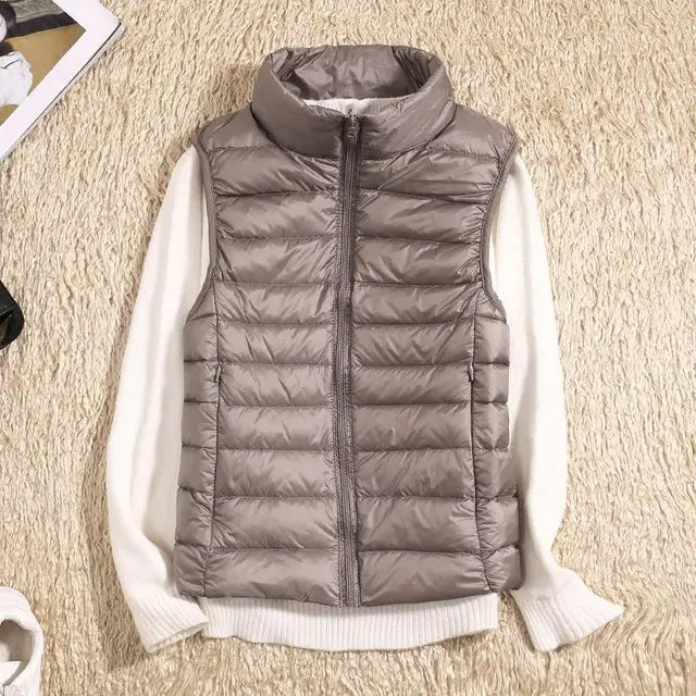 Cozy women's warm down vest in a soft cream. Lightweight sleeveless jacket for comfortable fall & winter layering.