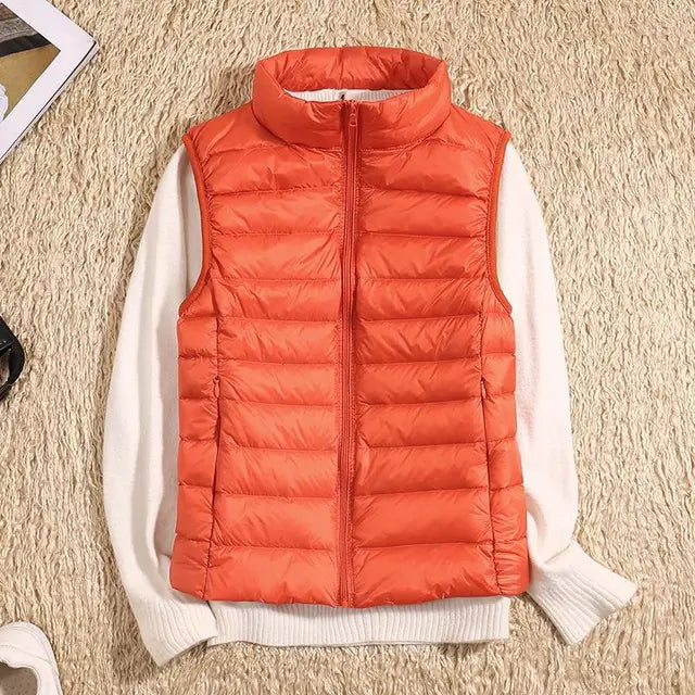 Chic women's olive green lightweight down vest. Warm & breathable sleeveless jacket for active fall wear.