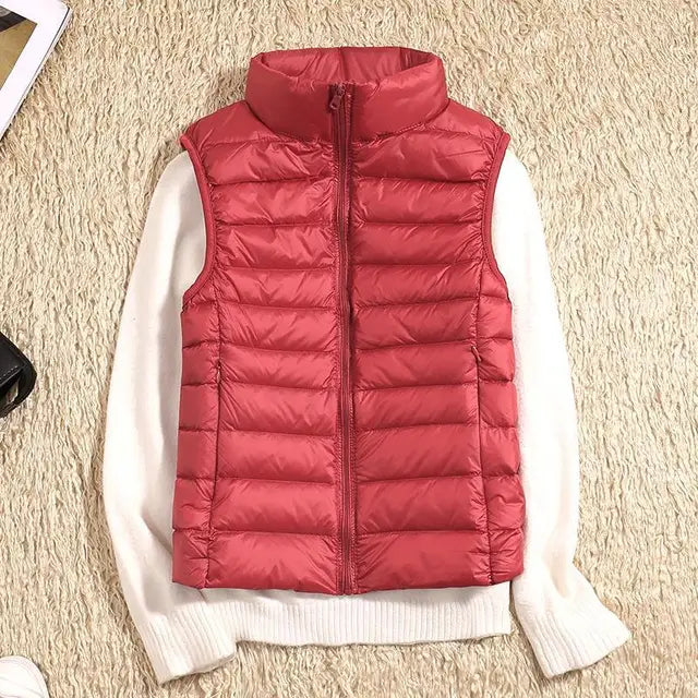Easy-to-pack women's down vest in classic grey. Lightweight & warm, perfect travel vest for any destination.