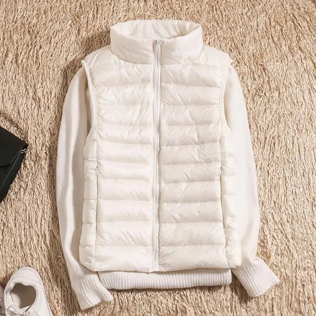 Women's warm down vest in crisp white, ideal for layering over sweaters. Ultra-light & stylish fall outerwear.