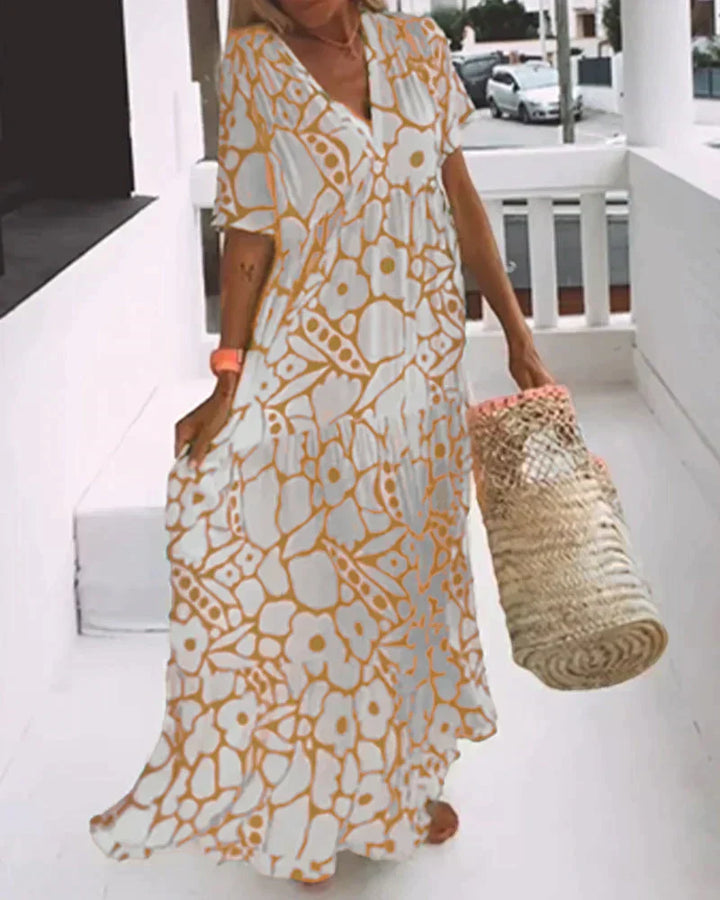 Flowing women's summer maxi dress with vibrant abstract print & elegant V-neck. Ideal for casual or vacation.