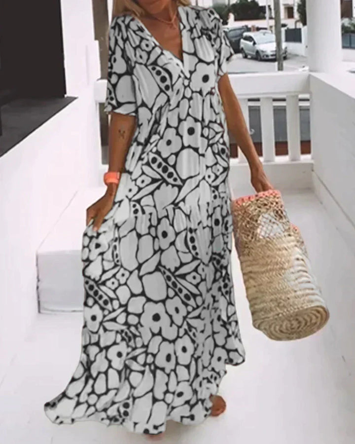 Feminine V-neck maxi dress with a bold abstract pattern, designed for a comfortable & flowy summer style.