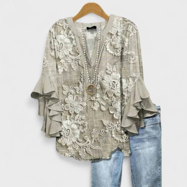 Women's elegant V-neck blouse with flowy ruffle sleeves, great for spring/summer wear.