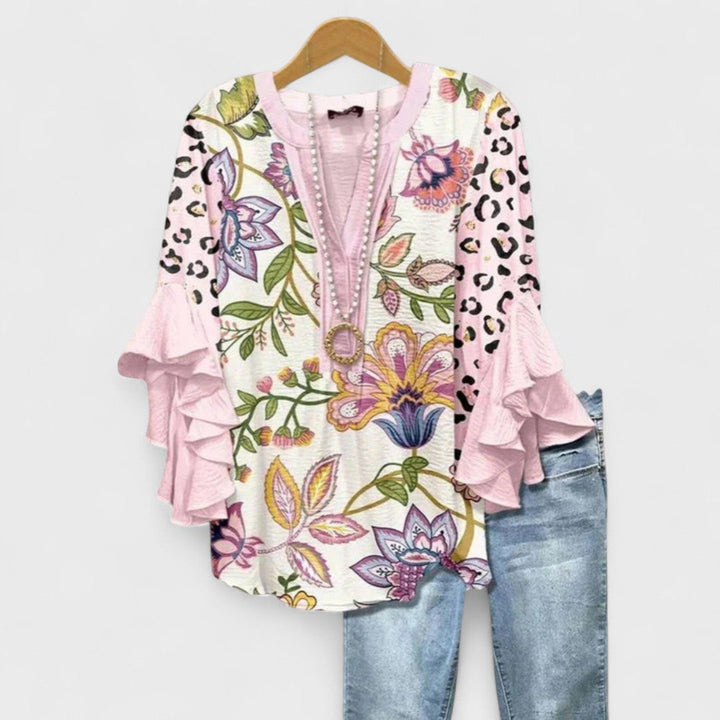 Casual yet elegant V-neck ruffle sleeve women's blouse, a trendy top for spring fashion.