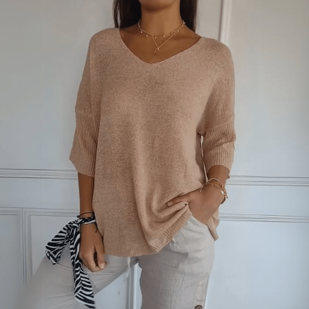 Stylish women's V-neck sweater with loose silhouette & three-quarter sleeves. Perfect for casual comfort.