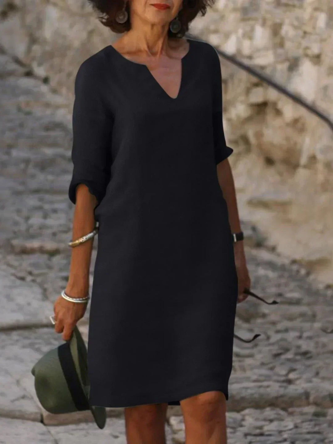 Women's V-neck relaxed fit midi dress with three-quarter sleeves. Perfect for casual elegant summer style.