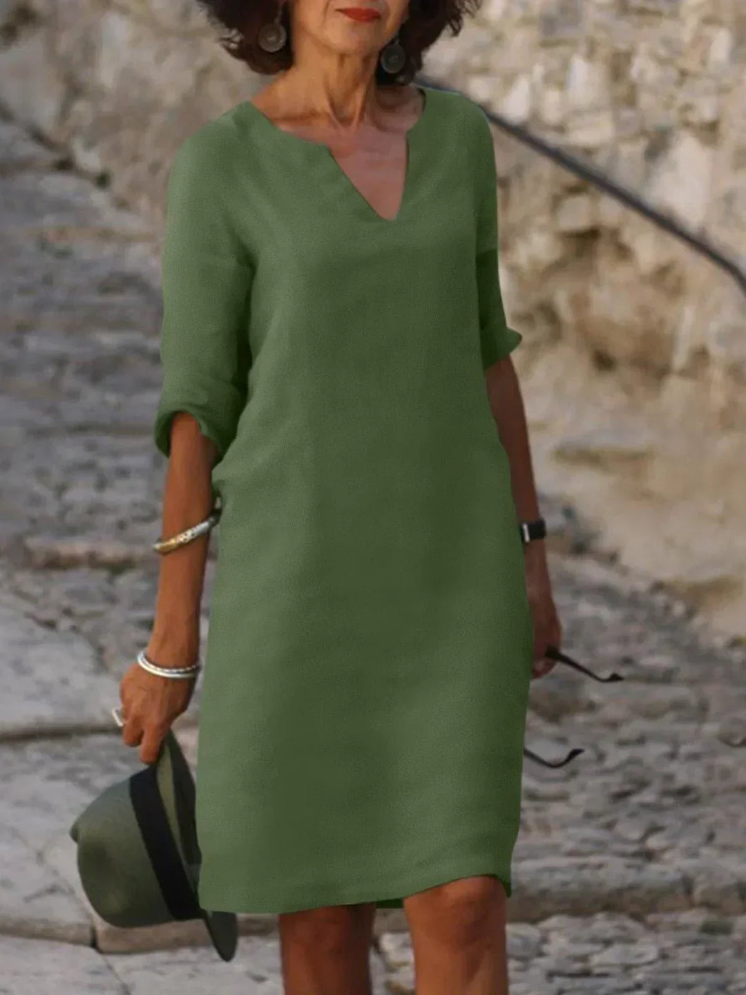 Comfortable women's v-neck midi dress with three-quarter sleeves & pockets. Relaxed fit for everyday wear.