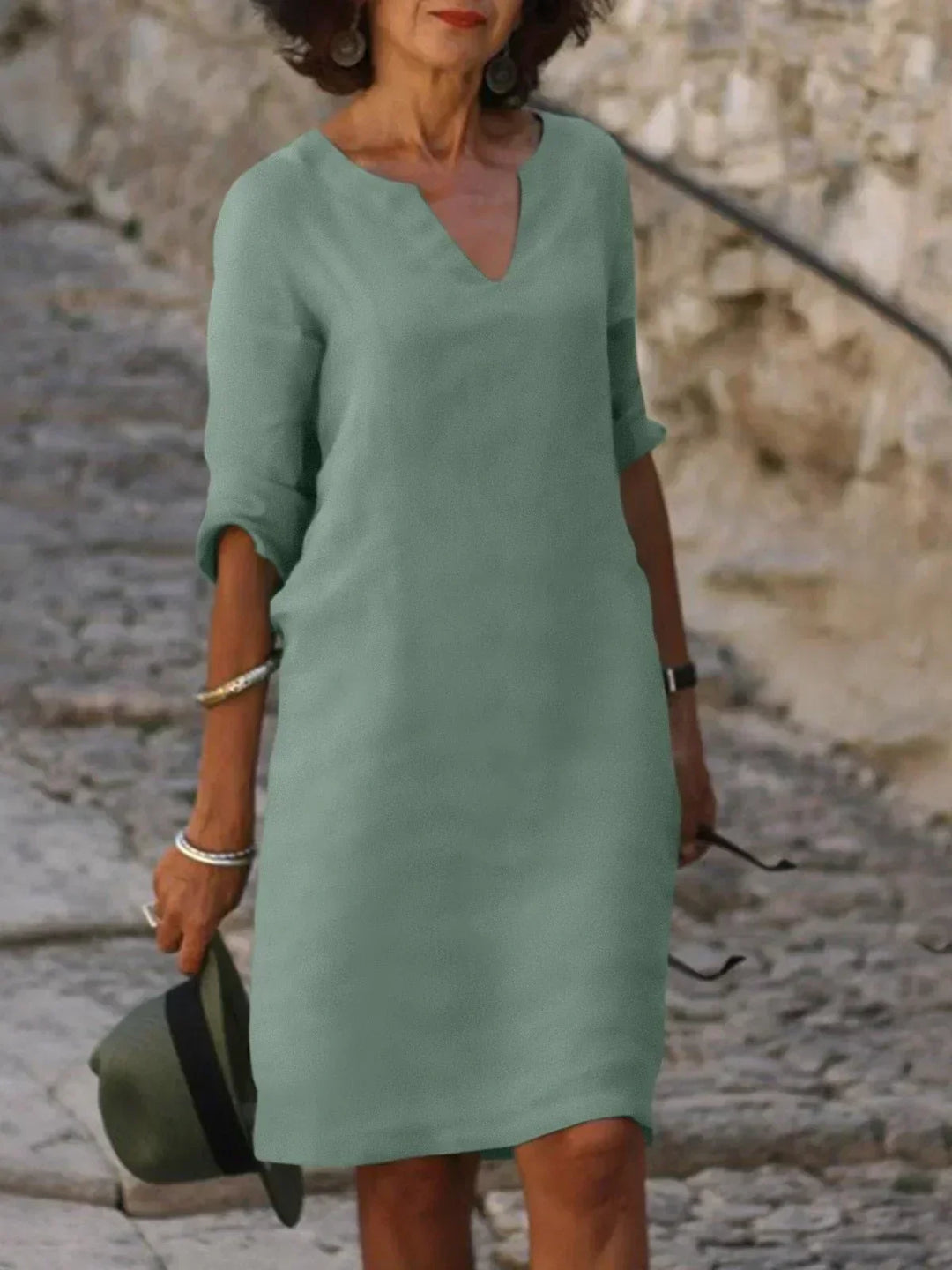 Chic women's v-neck midi dress, three-quarter sleeves. Relaxed fit for stylish summer fashion & travel.