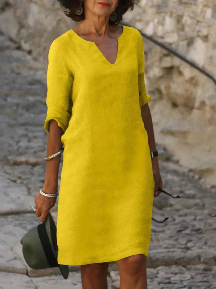 Relaxed fit women's v-neck midi dress, three-quarter sleeves. Ideal for casual elegant day to night style.