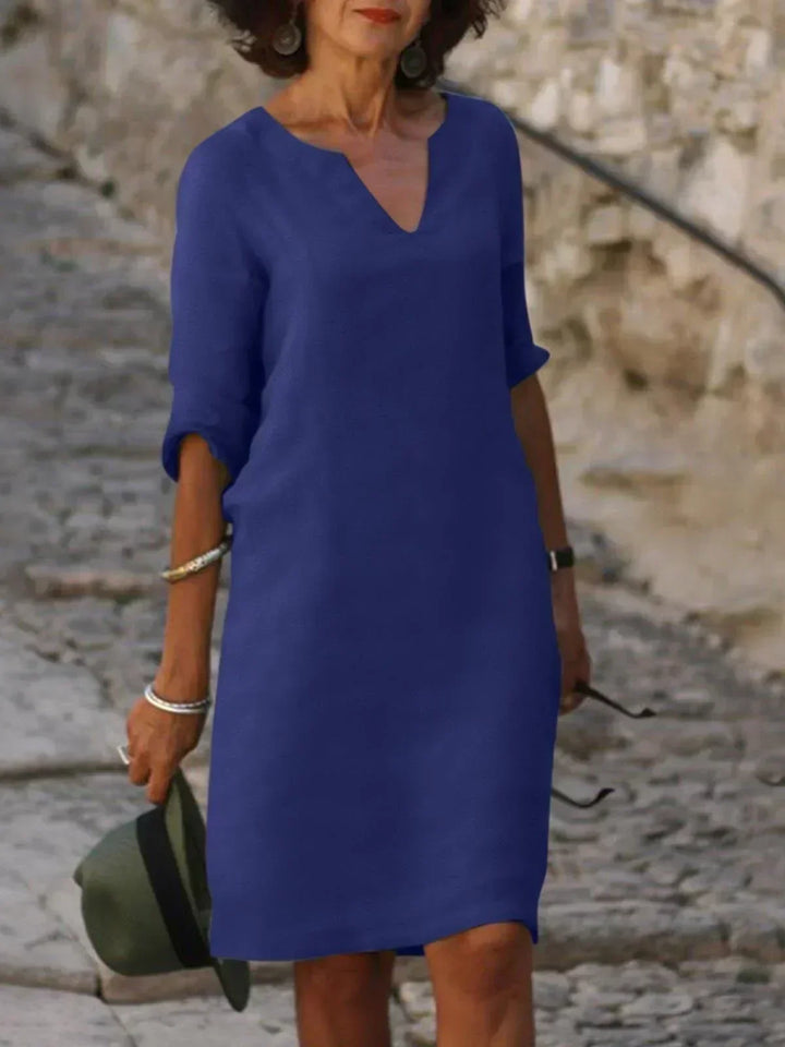 Women's v-neck, three-quarter sleeve midi dress. Relaxed fit, versatile, travel-friendly, with pockets.