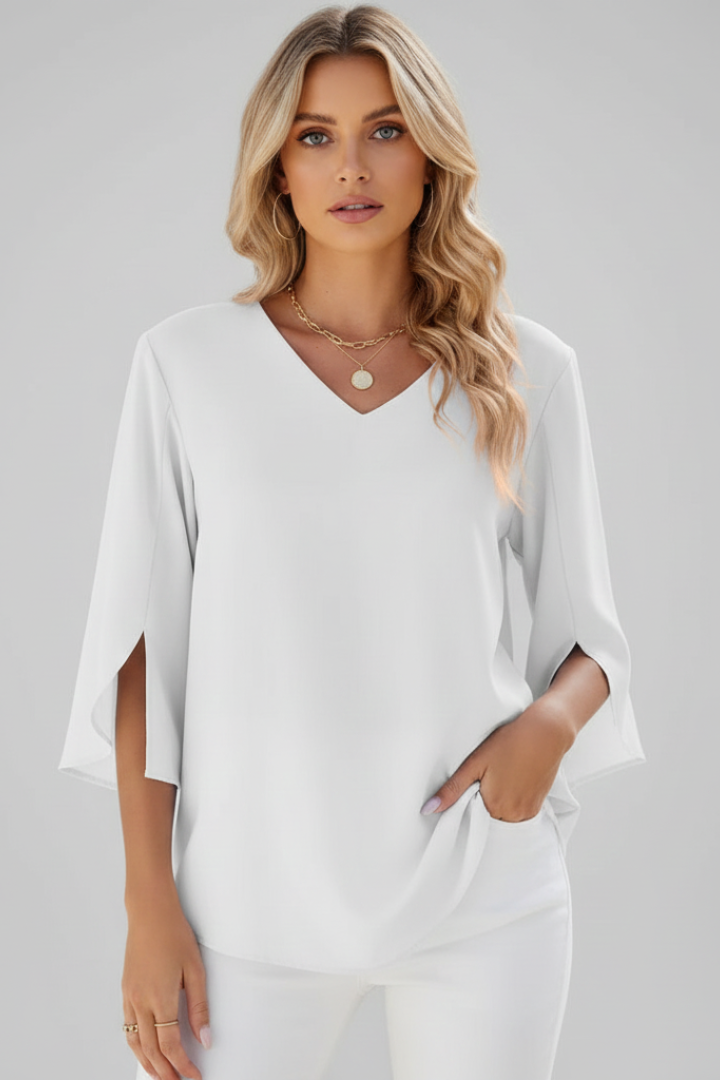 Loose fit women's V-neck blouse with short sleeves, perfect for comfortable everyday wear. Stylish and elegant.