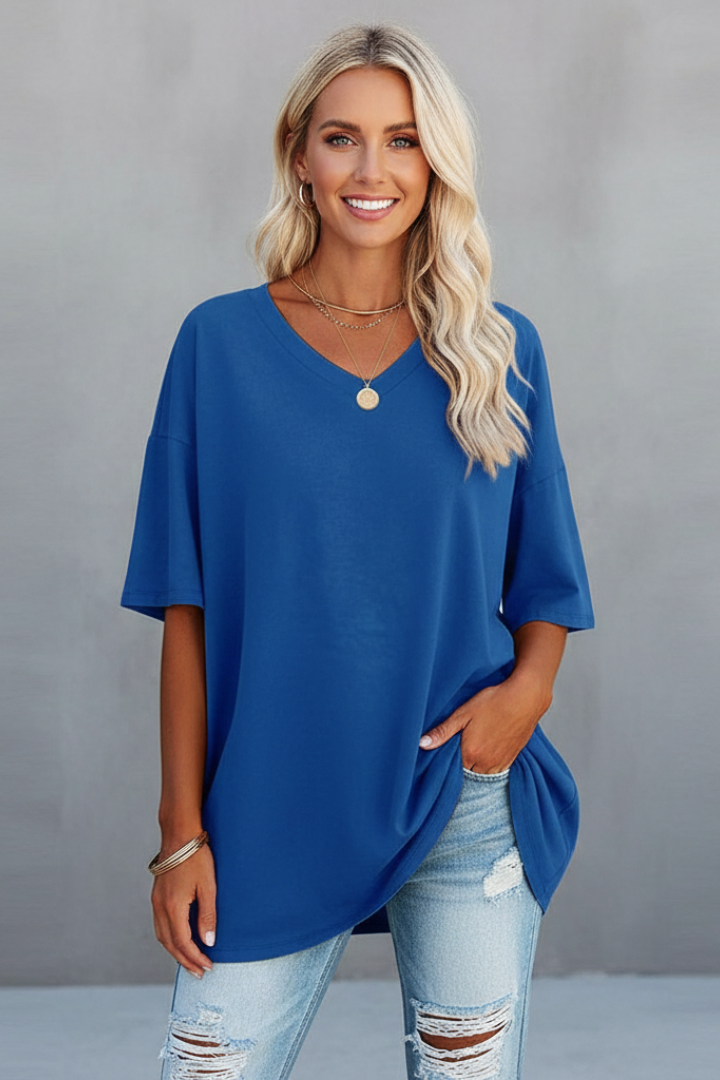 Model wearing a women's V-neck t-shirt with loose fit & short sleeves for casual everyday comfort.