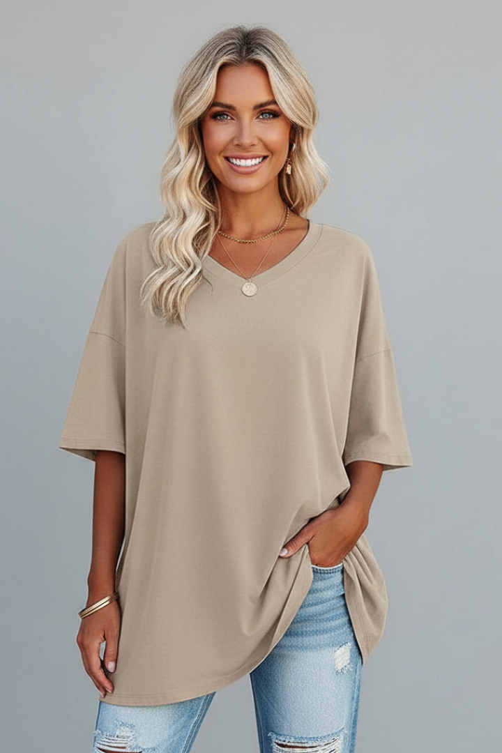 Close-up of V-neckline & short sleeves on a comfortable women's loose fit t-shirt, casual wear.
