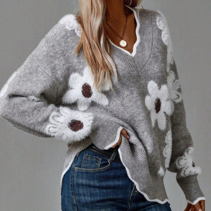 Women's V-neck sweater with elegant textured floral detail, ideal for casual wear.