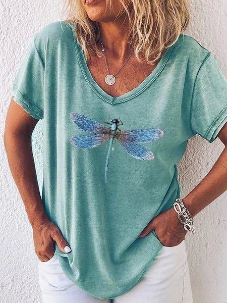 Close-up of a nature-inspired women's V-neck tee with vibrant dragonfly graphic. Casual short sleeve top for spring.