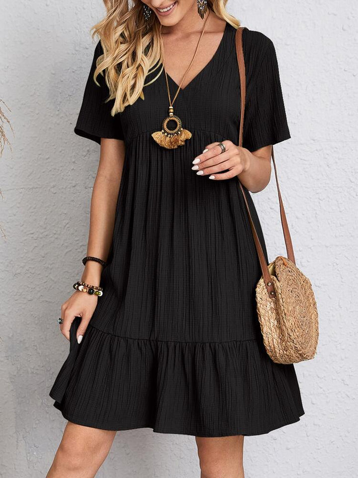 Effortless women's V-neck tiered mini dress, comfortable and stylish.