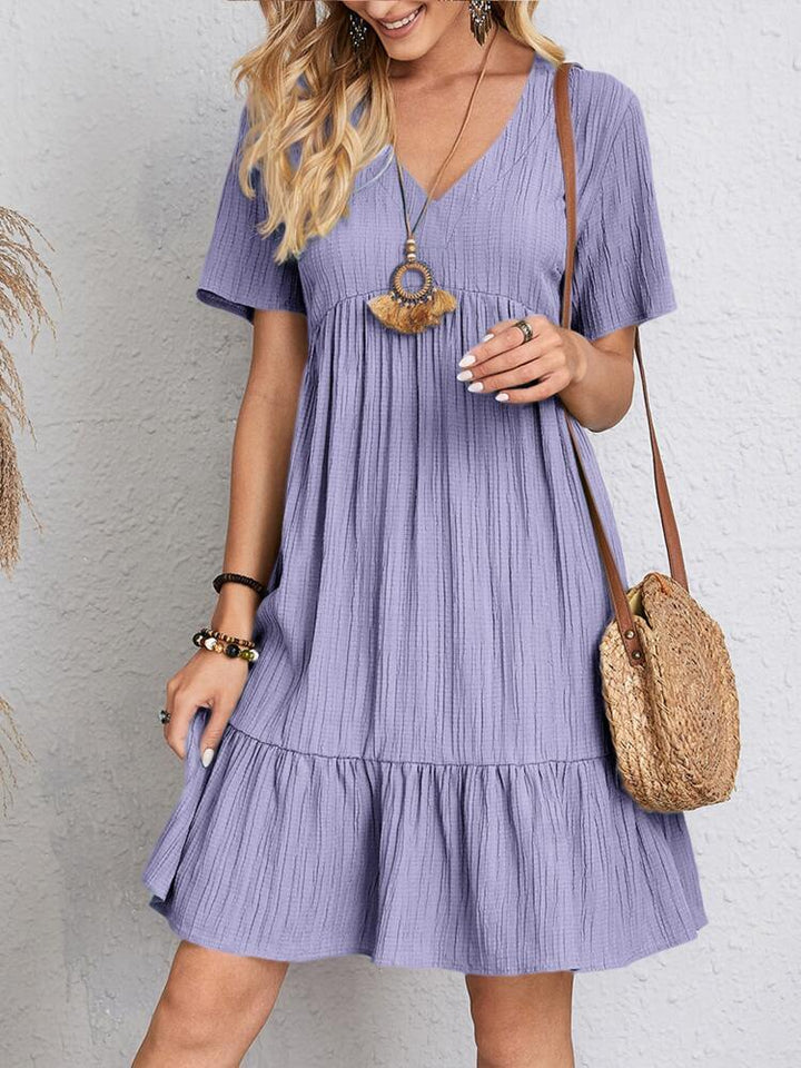 Comfortable short sleeve V-neck tiered mini dress for women, perfect for warm weather.