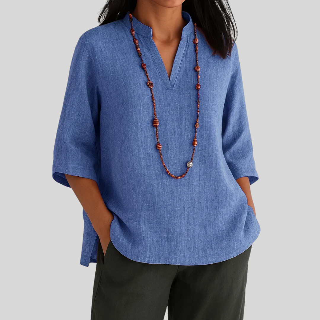 Elegant women's textured V-notch blouse with three-quarter sleeves. Sophisticated spring-summer daily wear top.