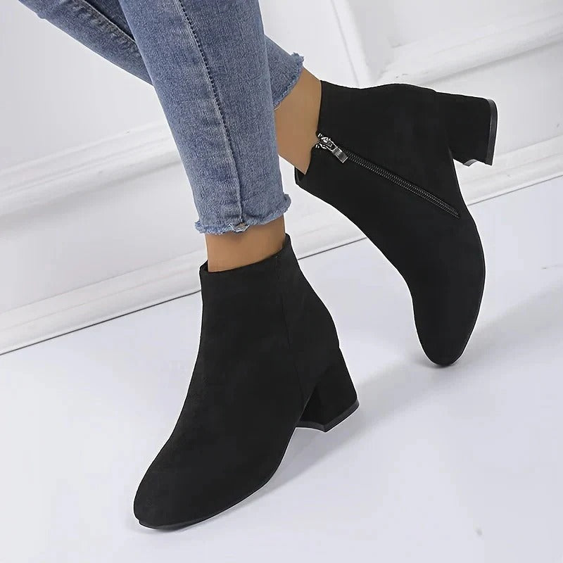 Stylish women's ankle boots with a robust block heel and convenient side zip, great for casual elegance.