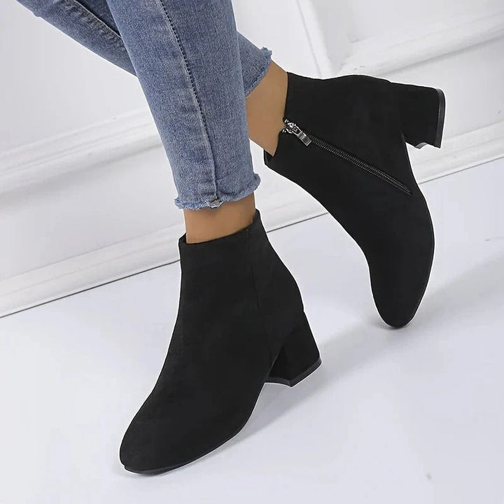 Stylish women's ankle boots with a robust block heel and convenient side zip, great for casual elegance.