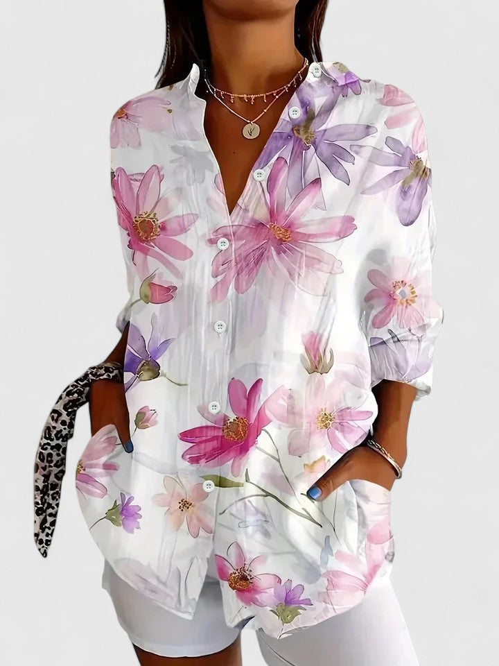 Vibrant women's printed blouse featuring a unique, colorful pattern. Versatile for spring & summer fashion.