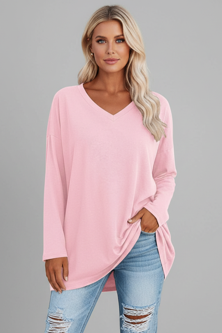 Women's v-neck long sleeve top paired with jeans, showcasing its casual and effortless style for daily outfits.