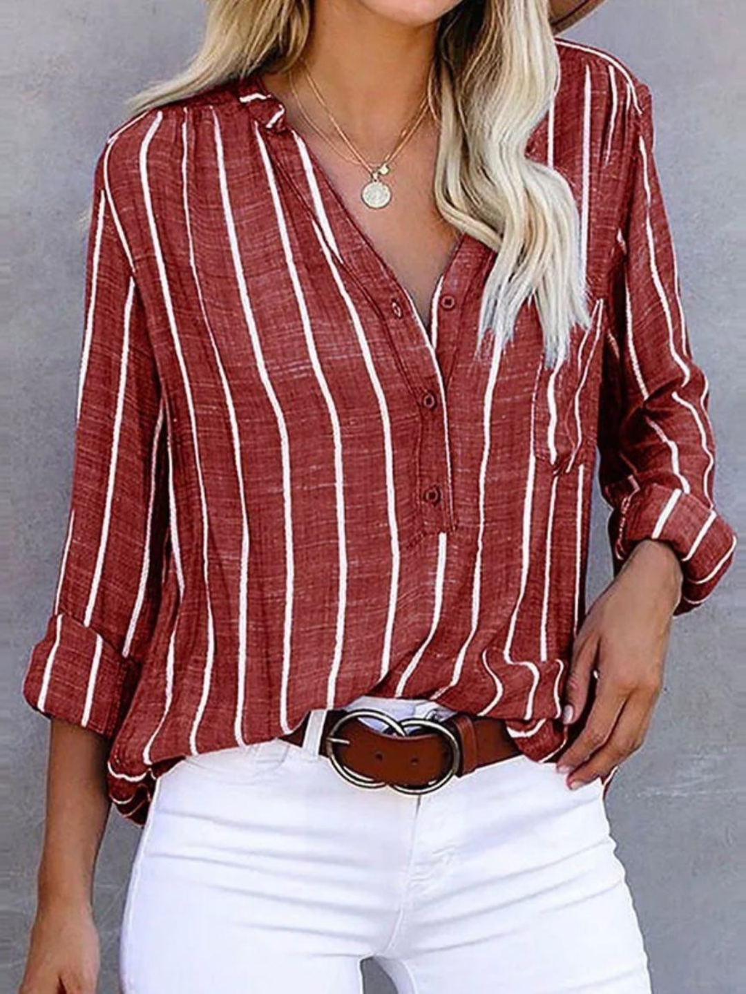 Relaxed fit women's vertical stripe long sleeve blouse. Chic V-neck button-front top for casual or workwear.