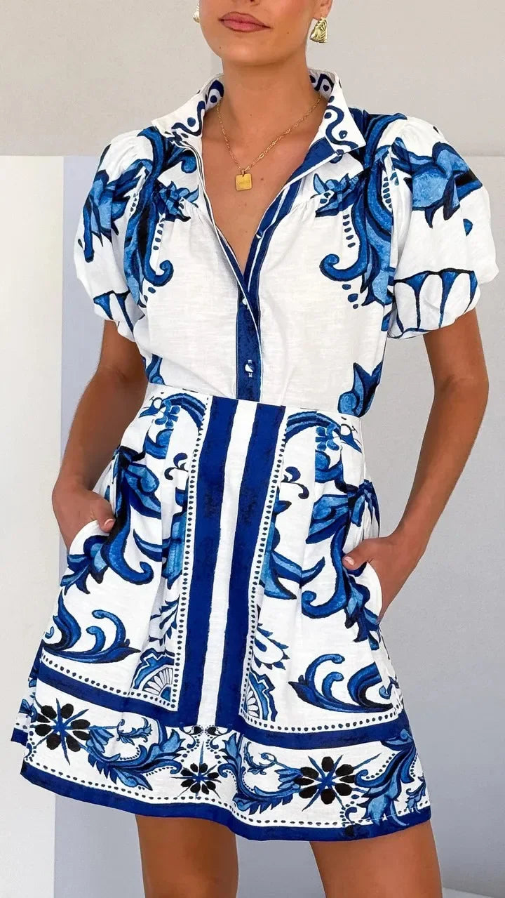 Women's vibrant floral mini cocktail dress with trendy puff sleeves.