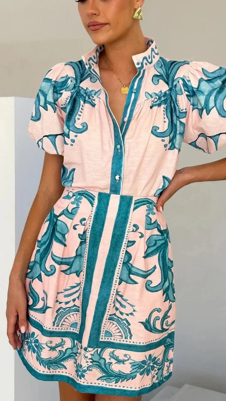 Vibrant women's floral mini dress with elegant puff sleeves, ideal for cocktail hour.