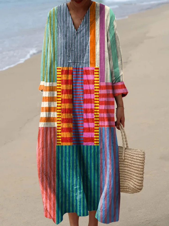 Women's vibrant patchwork print maxi dress with long sleeves & V-neck. Elegant casual summer fashion.
