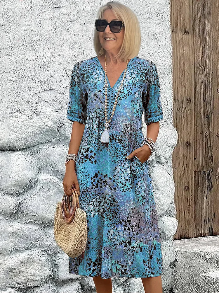 Relaxed fit vibrant print flowy midi dress for women. Features functional pockets, great for casual summer & spring.