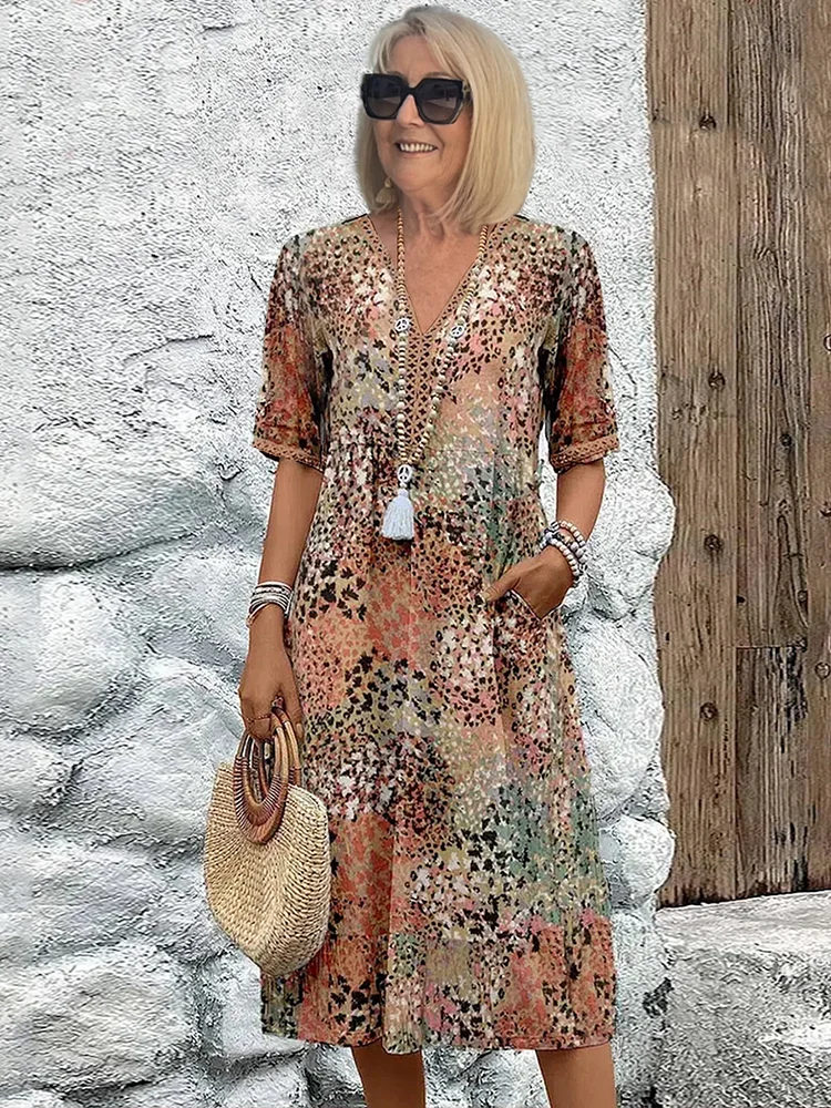Effortless women's vibrant print flowy midi dress. Versatile casual or elegant style with functional pockets. Spring/summer.