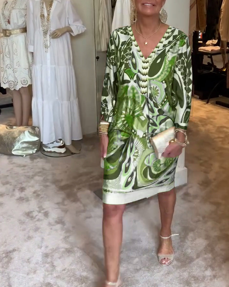 Model wearing a women's sunburst printed tunic dress, styled for a relaxed, fashionable summer look.