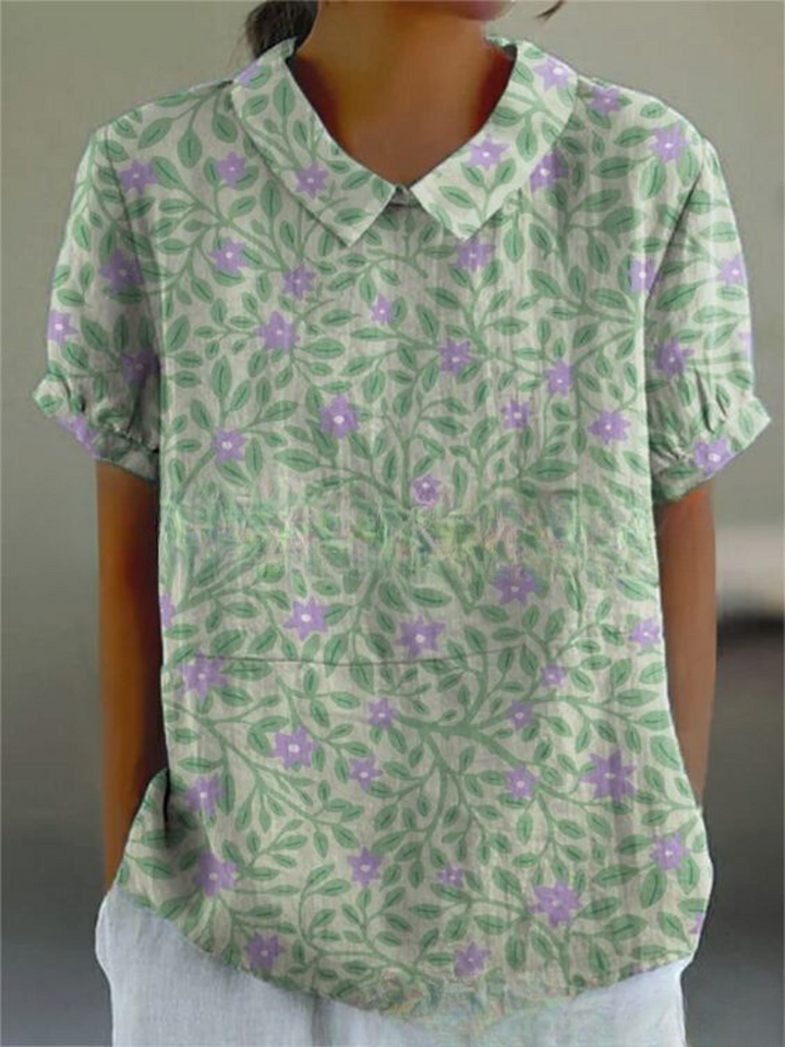 Casual women's floral print blouse, short sleeve & collared, ideal for warm weather.