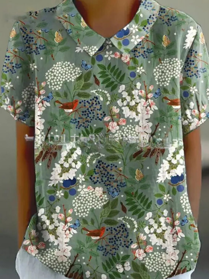 Vintage-inspired ladies floral top with detailed embroidery, short sleeves & a relaxed fit.