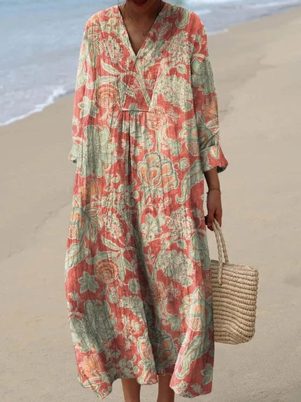 Flowy boho midi dress for women, featuring a vibrant artistic floral print & practical pockets. Ideal for summer comfort.