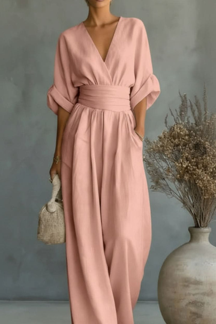 Chic pink women's vintage style jumpsuit. Versatile one-piece for casual, evening, or party outfits. Flexible fit.