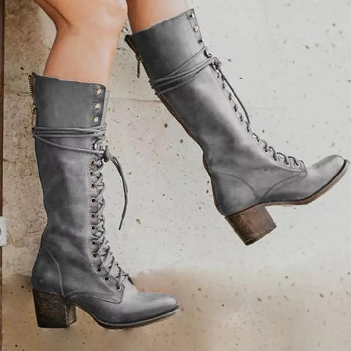 Stylish women's lace-up boots with a sturdy block heel, offering a vintage look and comfortable fit.