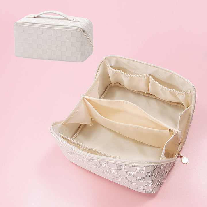 Women's cosmetic bag in vintage pattern next to everyday essentials, travel ready
